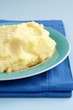 mashed potatoes in a bowl and a blue cloth on the table mashed potatoes in a bowl and a blue cloth on the table