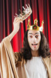 Funny king against red curtain Funny king against red curtain