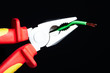Pliers with electrical cables.