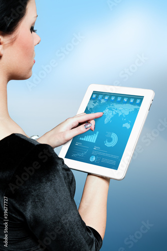 Photo: Cute brunette using interface of new touch pad device Cute brunette using interface of new touch pad device