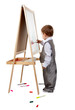 A child paints on an easel in the studio