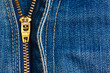 Close up of a zipper over blue denim Close up of a zipper over blue denim