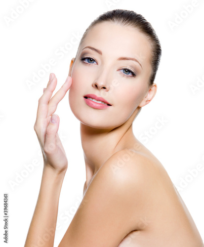 Photo: Beautiful woman touching the cheek on face Beautiful woman touching the cheek on face