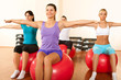 group of gym people in a pilates class