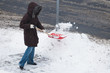 Woman shoveling snow