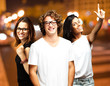 portrait of happy young people at city by night