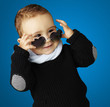 portrait of funny kid wearing heart sunglasses against a blue ba portrait of funny kid wearing heart sunglasses against a blue ba