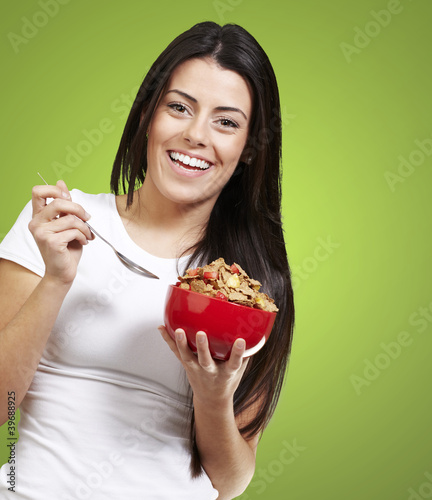 Photo: woman holding a bowl with cereals woman holding a bowl with cereals