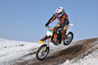 Motocross racer flying down the mountain