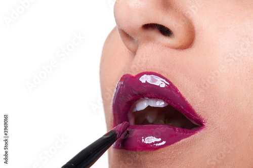 Photo: Close up of glossy red bright lips application. Close up of glossy red bright lips application.