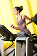 gym: young woman Running on treadmill