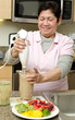 Photo: Senior asian filipino woman preparing food Senior asian filipino woman preparing food