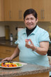 Photo: Senior asian filipino woman preparing food Senior asian filipino woman preparing food