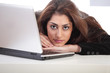 Pretty girl resting head on laptop Pretty girl resting head on laptop