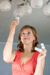 Girl changes  bulb