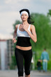 Woman running in green park
