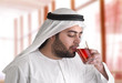arabian guy drinking tea against a nice moody background