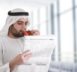 arabian business man drinking tea & reading news-