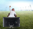 arabian man watching TV and reacting - front view
