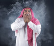 deep fear of an arabian businessman against a smokey background