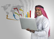 successful arabian business man performing stock works on laptop