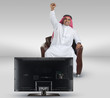 arabian man watching TV and reacting