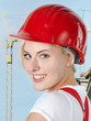 Young girl with red helmet wants to build a house