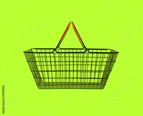 Photo: shopping basket on green shopping basket on green