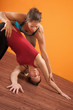 Yoga Trainer Assisting Student