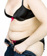 Fat woman trying to put on her tight jeans