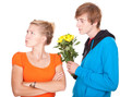 man offering flowers to his girlfriend after argument