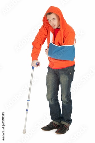Photo: man with broken hand walking on crutc full length man with broken hand walking on crutc full length