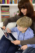 mother and son playing with digital tablet