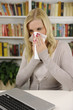 Woman with flu or allergy sneezing