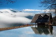 Dramatic clouds with mountain and small house
