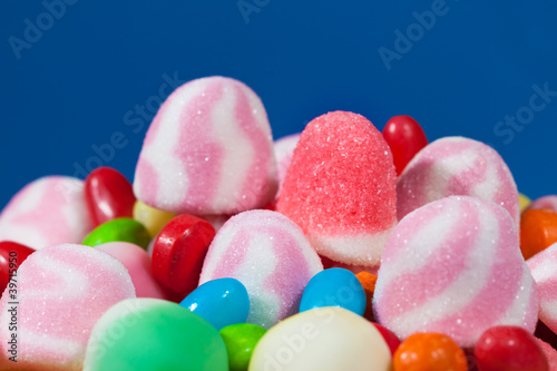 Photo: Candy assortment on blue background Candy assortment on blue background