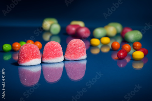 Photo: Candy assortment on blue background Candy assortment on blue background