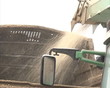 Wood branch sawdust chips pour crumble in trailer. Green biofuel