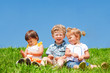 Kids sit on grass