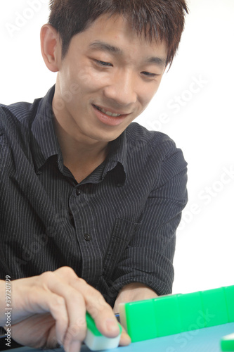 Photo: Chinese man play Mahjong, traditional China gamble. Chinese man play Mahjong, traditional China gamble.