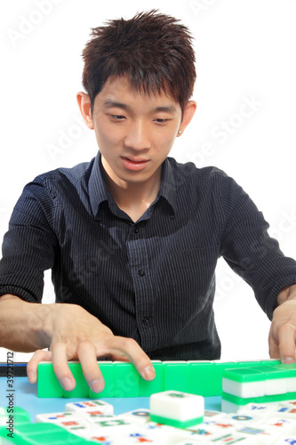 Photo: Chinese man play Mahjong, traditional China gamble. Chinese man play Mahjong, traditional China gamble.