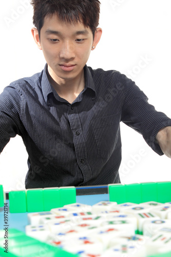 Photo: Chinese man play Mahjong, traditional China gamble. Chinese man play Mahjong, traditional China gamble.