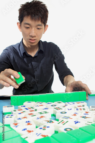 Photo: Chinese man play Mahjong, traditional China gamble. Chinese man play Mahjong, traditional China gamble.