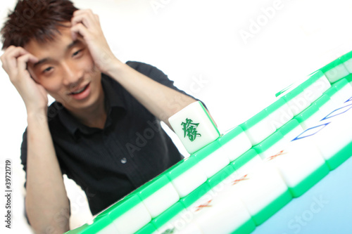 Photo: Chinese man play Mahjong, traditional China gamble. Chinese man play Mahjong, traditional China gamble.