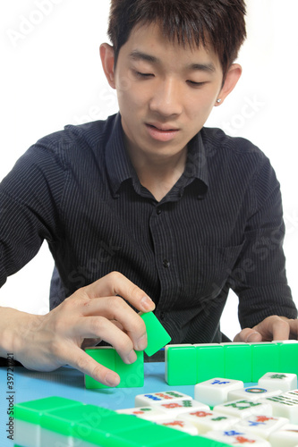 Photo: Chinese man play Mahjong, traditional China gamble. Chinese man play Mahjong, traditional China gamble.