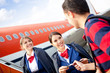 Flight attendants welcoming passenger