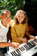 ethnic old mother and son happy playing piano together ethnic old mother and son happy playing piano together