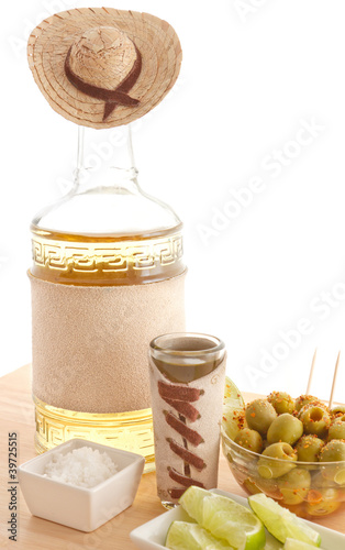 Photo: Tequila bottle with sombrero and rough leather label Tequila bottle with sombrero and rough leather label