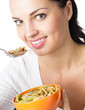 Foto: Woman eating muesli or cornflakes, isolated Woman eating muesli or cornflakes, isolated