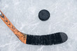 ice hockey stick and puck on ice